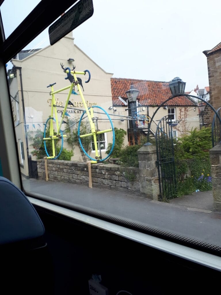 The Hart Inn, Sandsend, with a gigantic yellow Tour de Yorkshire bike outside. Pic taken in a hurry from the X4 bus, 2/5/19.